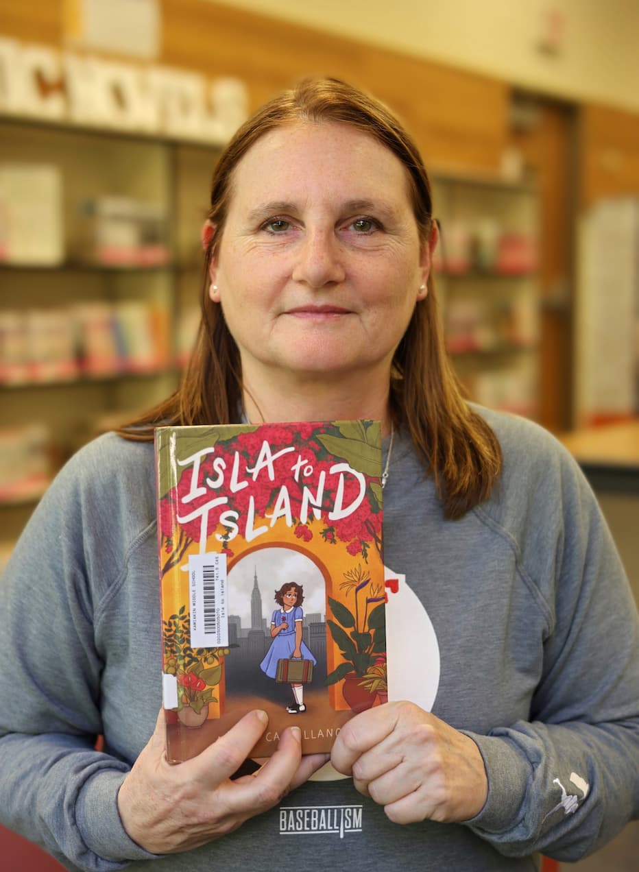 Kamiakin Middle School Librarian with Book